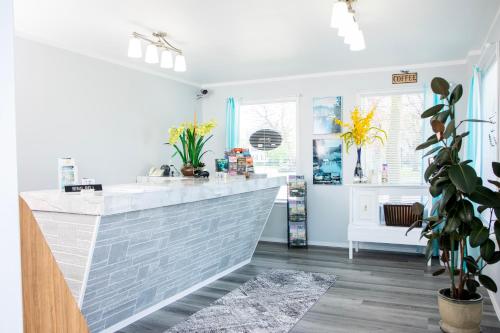 a kitchen with a white counter and some plants at Starlite Motel in Wisconsin Dells