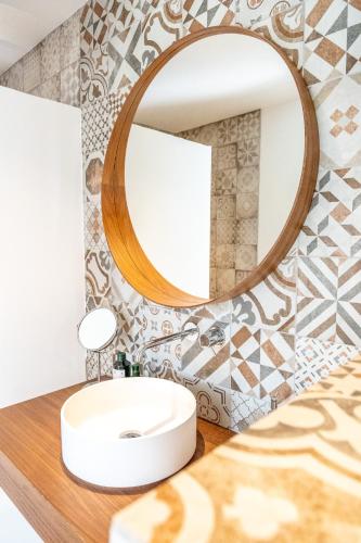 une salle de bain avec un lavabo et un miroir dans l'établissement Provence - Studio classé 4 étoiles entre terre et mer - piscine, pétanque, à La Londe-les-Maures