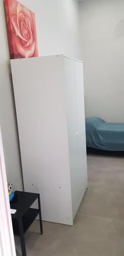 a white cabinet in a room with a bed at GIOIA Holiday Home in Torre del Greco