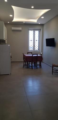 a large room with a table and a window at GIOIA Holiday Home in Torre del Greco