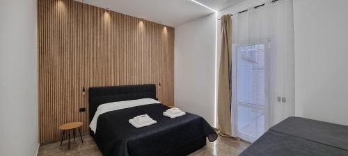 a bedroom with a bed with two towels on it at La Peonia B&B in Ragusa
