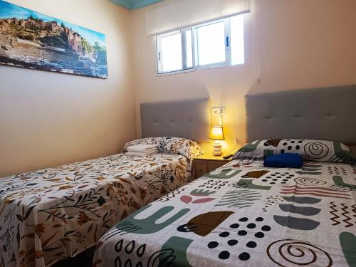 a bedroom with two beds and a window at RIV - Reformado, Terraza con vistas al mar, 1 dormitorio, 800 metros de la Playa in Torremolinos