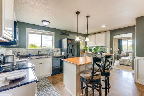 a kitchen with white cabinets and a table and chairs at Perfect for Families! Spokane Valley Home with Yard in Spokane Valley