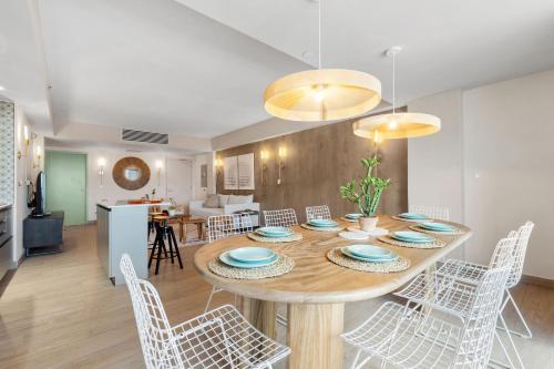 a dining room and living room with a table and chairs at HiBird- Apartment and Suites Hotel in San Juan