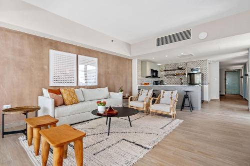 a living room with a couch and a table at HiBird- Apartment and Suites Hotel in San Juan
