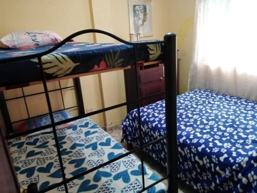 a bedroom with two bunk beds and a window at Jamaica in Fusagasuga