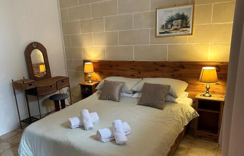 a bedroom with a bed with two pillows on it at Green Grove Guest House in St Julian's