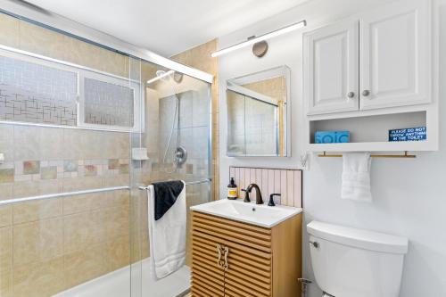 a bathroom with a toilet and a sink and a shower at California Dreamin in Oceanside