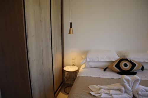 a bedroom with a bed with towels on it at Merelia Luxury Guesthouse in Haraki