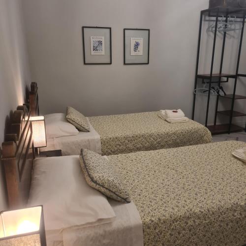 a room with three beds sitting next to each other at Cascina Antiche Terre in Campegine