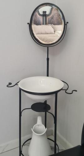 a mirror on top of a table with a vase at Cascina Antiche Terre in Campegine