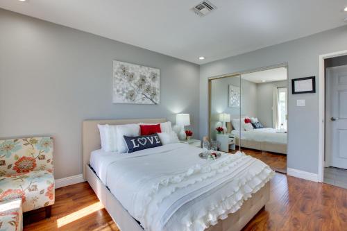 a bedroom with a large white bed and a mirror at Las Vegas Retreat with Yard Less Than 5 Mi to Strip! in Las Vegas