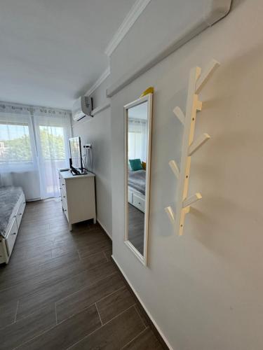 a room with a mirror and a bedroom with a bed at Sétány Kuckó Apartman in Balatonfüred