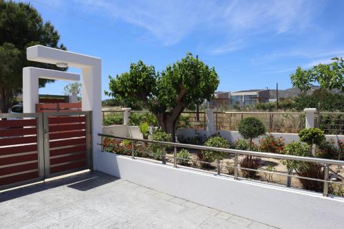 a balcony with a wooden gate and some plants at Merelia Luxury Guesthouse in Haraki