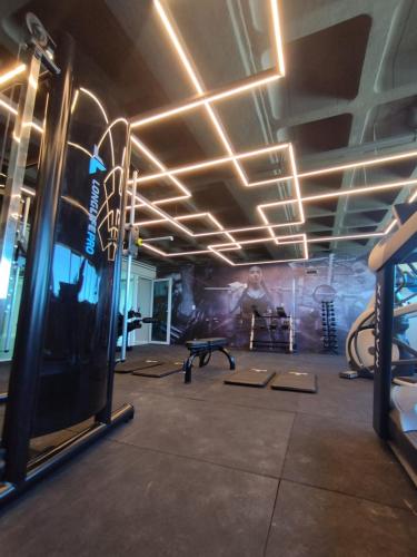 a room with a gym with a man on the wall at RN STUDIOs PREMIUM 621 in Maceió