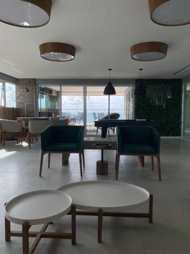 a living room with two tables and a pool table at RN STUDIOs PREMIUM 621 in Maceió