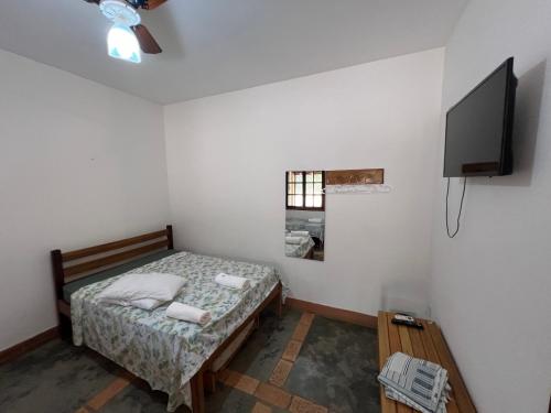 Ein Bett oder Betten in einem Zimmer der Unterkunft Pousada Complexo Paraíso - Parque Nacional da Serra da Canastra