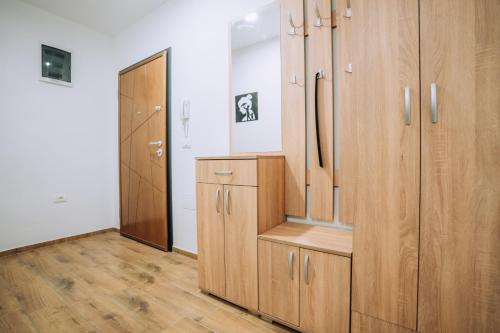 a dressing room with wooden cabinets and a hallway at Darki Apartments 2 - Very Central Stay With Free Parking in Ohrid