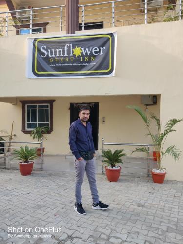 a man is standing in front of a building at Sunflower Guest inn in Kano
