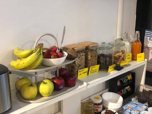 a bunch of fruits and vegetables on shelves in a kitchen at La Sosta nel Borgo in Anguillara Sabazia