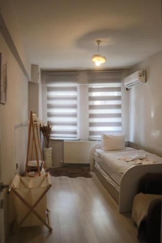 a bedroom with a bed and a window with blinds at ERKUL OLD CITY in Istanbul