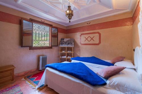 a bedroom with two beds and a window at Riad Tourtit in Imlil