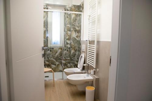 a bathroom with a toilet and a sink at Magic Home Torino in Turin