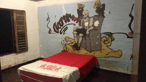 una camera da letto con un dipinto sul muro di Casa de praia Vera a Caucaia