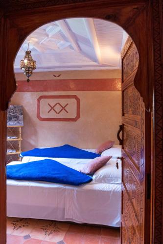 a bedroom with two beds in an arch way at Riad Tourtit in Imlil