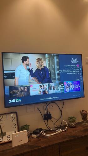 TV de pantalla plana en la parte superior de un escritorio en شقه مفروشة فاخره بدخول ذاتي, en Al Kharj