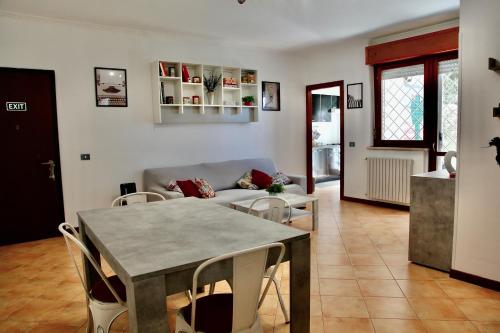a living room with a table and chairs and a couch at 4four Apartment 6-7 pax in Vitinia