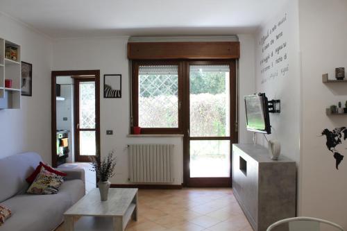 a living room with a couch and a tv at 4four Apartment 6-7 pax in Vitinia