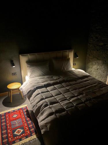 a bedroom with a large bed and a table at Art House Kruje in Krujë