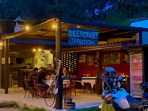 a group of people sitting at a restaurant at night at Art House Kruje in Krujë