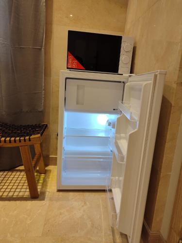 an open refrigerator with a tv on top of it at HABITACION CON HERMOSAS VISTAS A BILBAO in Bilbao
