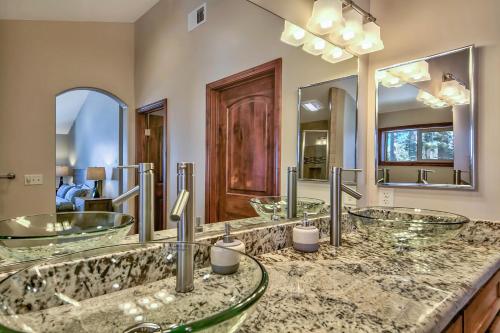 a bathroom with three sinks and two mirrors at Tahoe Woods 203 at Stateline Heavenly Slopes Lake in South Lake Tahoe