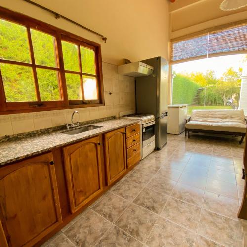 a kitchen with a sink and a large window at Cabaña privada en Valle Grande San Rafael in Valle Grande
