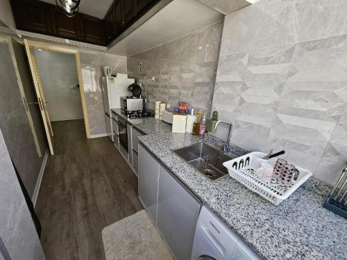 a kitchen with a sink and a counter top at Cosy and Complete Casa appartment in Casablanca