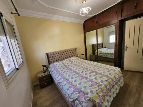 a bedroom with a bed and a mirror at Cosy and Complete Casa appartment in Casablanca