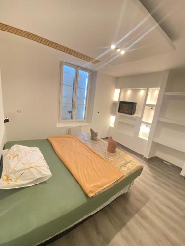 Un dormitorio con una cama con una sábana naranja. en Chambre spacieuse élégante en Beauvais