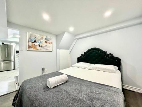 a bedroom with a bed with a pillow on it at Basement Unit 25-Minute Downtown in Toronto