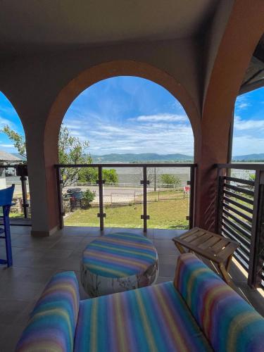 a porch with two beds and a view of the ocean at Apartmani Vera in Vinci