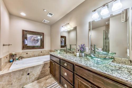 a bathroom with two sinks and a bath tub and a bath tub at Tahoe Woods 502 at Stateline Lake Heavenly Village in South Lake Tahoe