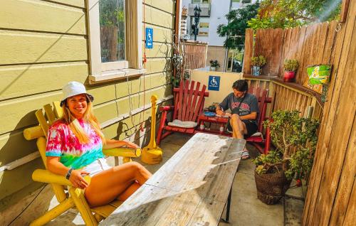 a woman sitting in a chair on a patio at ITH San Diego Adventure Hostel in San Diego