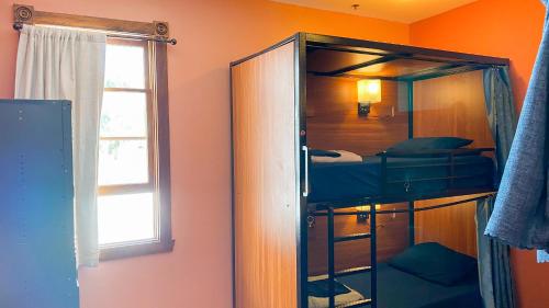 a room with a bunk bed and a window at ITH San Diego Adventure Hostel in San Diego