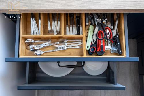 a wooden drawer with scissors and other tools in it at Premium Apartment Mechaniczna 5W in Głogów