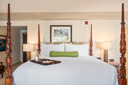 a bedroom with a large white bed with a tray on it at Hotel Bellwether on Bellingham Bay in Bellingham