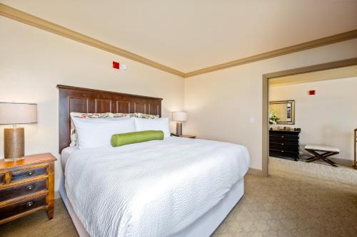 a bedroom with a large white bed and a mirror at Hotel Bellwether on Bellingham Bay in Bellingham