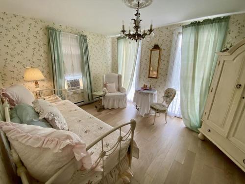 a bedroom with a bed and a chandelier at Walden on the Pond in Spring Lake