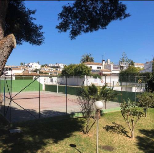 a tennis court with a net on a tennis court at Studio in Calypso,Calahonda 200 metres from the beach in Sitio de Calahonda